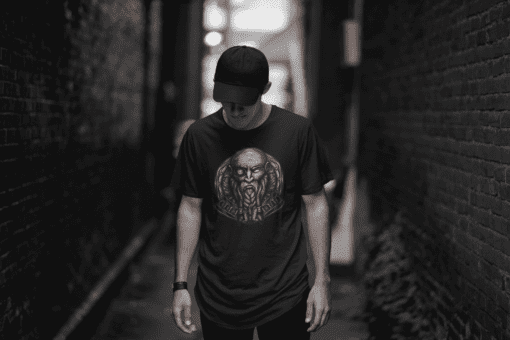 t shirt mockup of a cool man posing in a dark alley 2357 el1 - Varegue