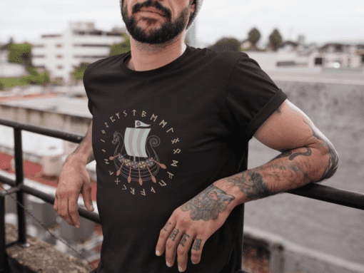 cropped face tattooed man wearing a t shirt mockup while lying against a fence on a rooftop a17027 - Varegue