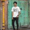 mockup of a man wearing a tee and posing in front of an old door m26132 - Varegue