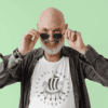 t shirt mockup featuring a smiling bald man taking off his sunglasses m27211 r el2 - Varegue