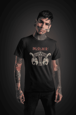 t shirt mockup of a goth man with a skull tattooed face standing at a studio 26593 - Varegue