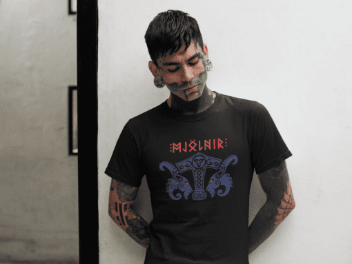 t shirt mockup of a tattooed goth man leaning on a white wall 26600 - Varegue